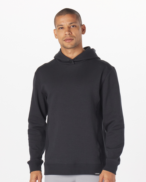 Black hoodie with kangaroo pocket and drawstring, worn by male model against white background.