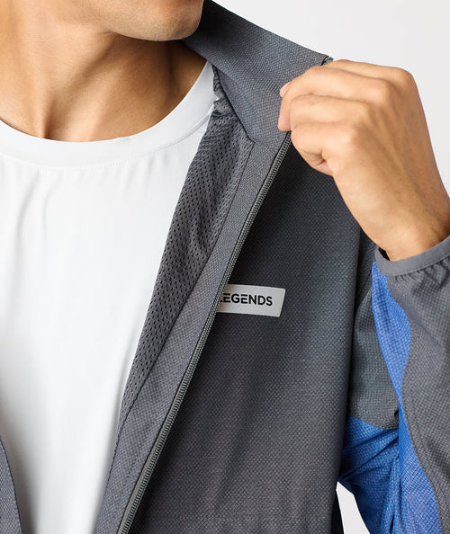 Charcoal full-zip jacket with textured fabric and blue accents, displayed unzipped over white shirt.