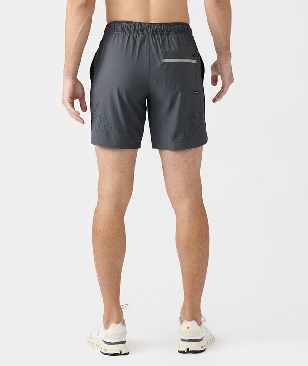Charcoal gray athletic shorts with perforated side panels, back pocket, and elastic waistband shown on male model from behind