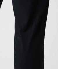 Black pant with perforated mesh panels along the thighs and lower legs.