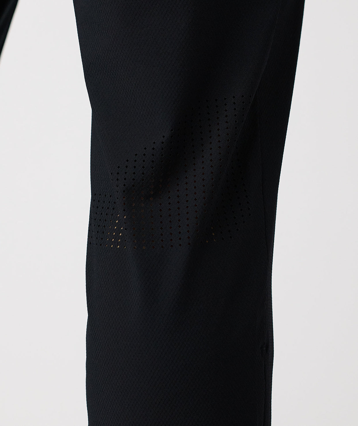Black pant with perforated mesh panels along the thighs and lower legs.