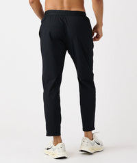 Black tapered athletic pants with elasticated waistband and mesh vents at the calves.