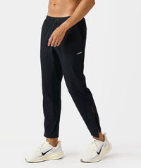Black Luka HD pant with drawstring waistband, side pockets, and ankle zippers on male model.