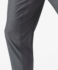 Charcoal gray pants with textured fabric and curved seam detail along the leg.