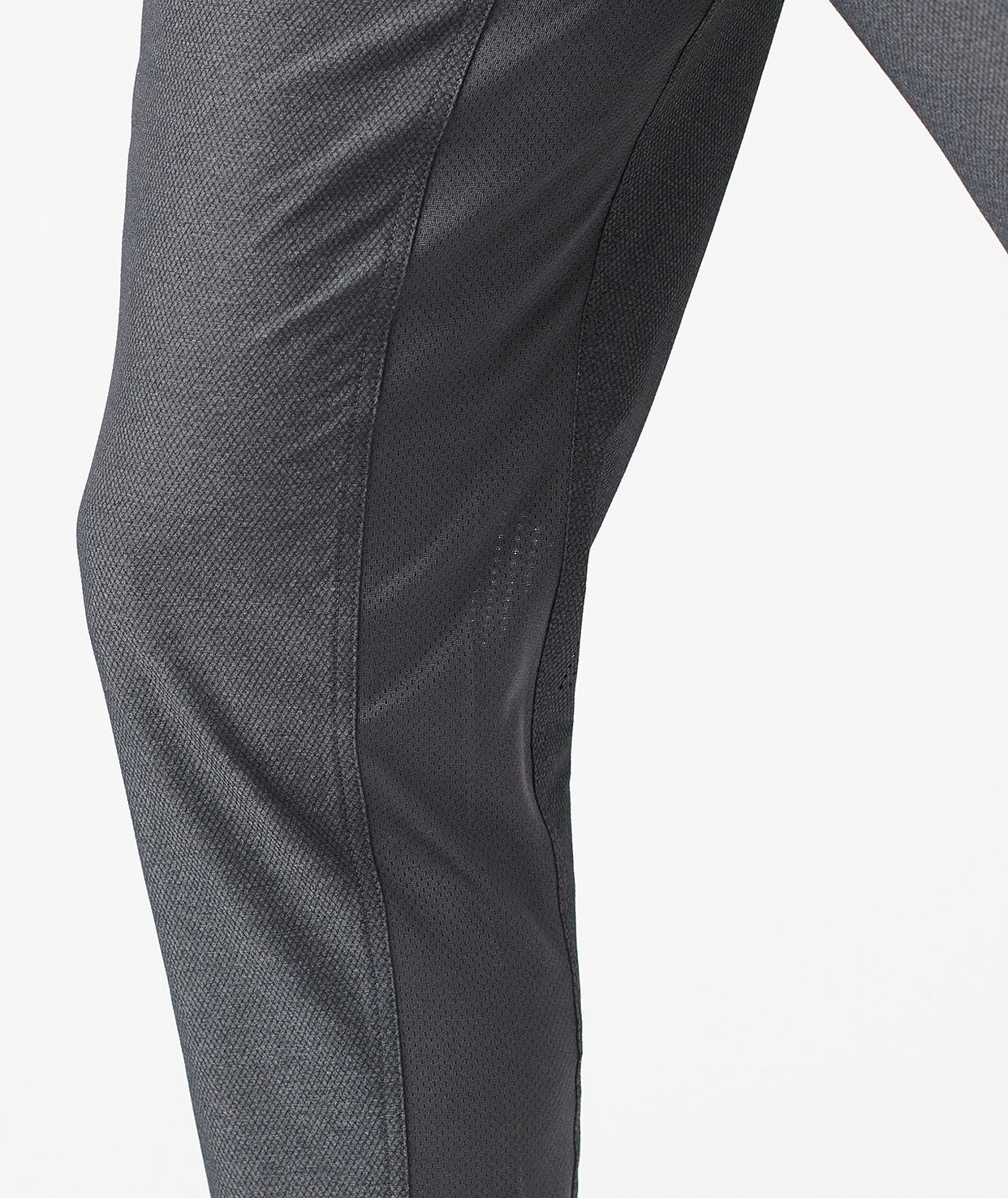 Charcoal gray pants with textured fabric and curved seam detail along the leg.