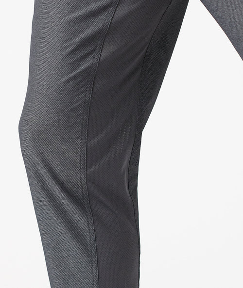 Charcoal gray pants with textured fabric and curved seam detail along the leg.