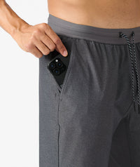 Charcoal gray pant with textured fabric and elastic waistband, shown with phone pocket detail and drawstring.
