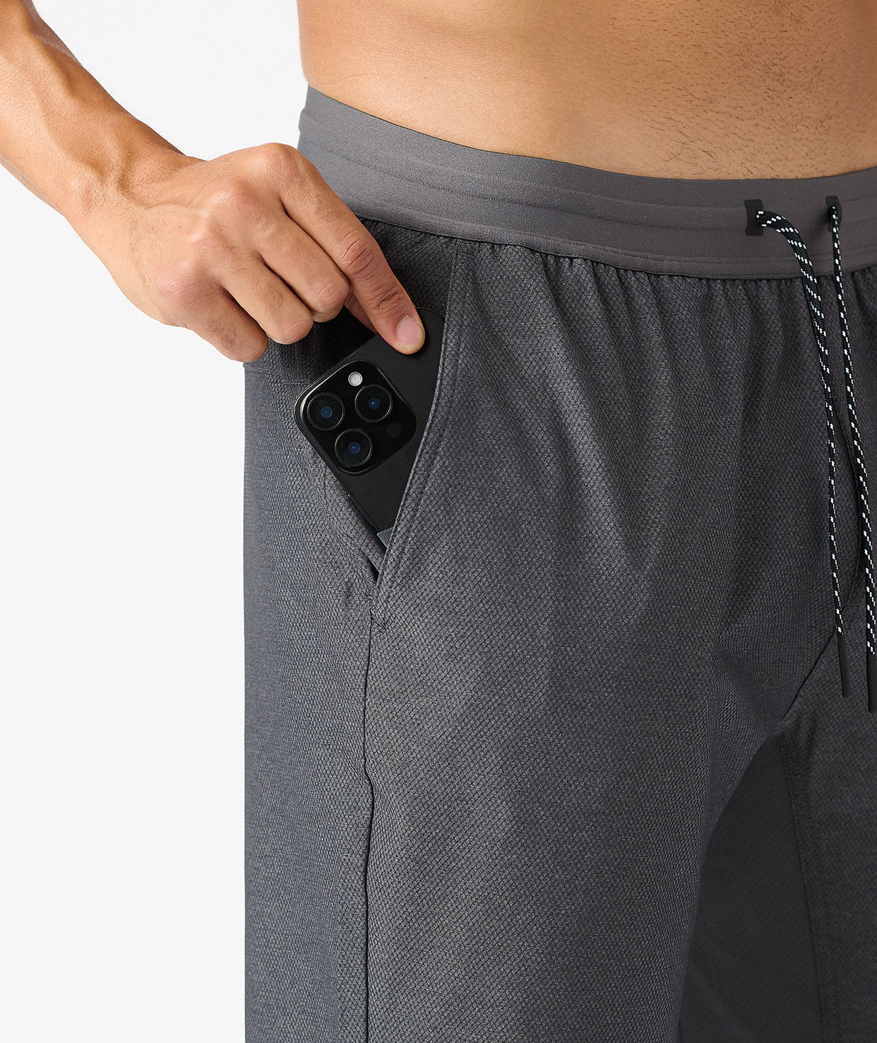 Charcoal gray pant with textured fabric and elastic waistband, shown with phone pocket detail and drawstring.