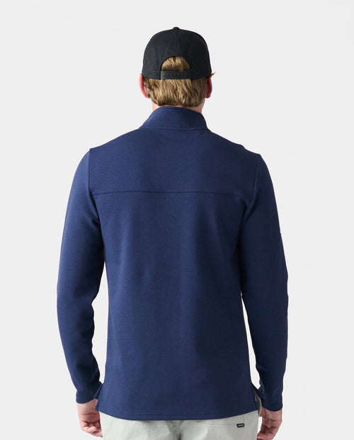 Navy quarter-zip pullover shown from back view on person wearing black cap.