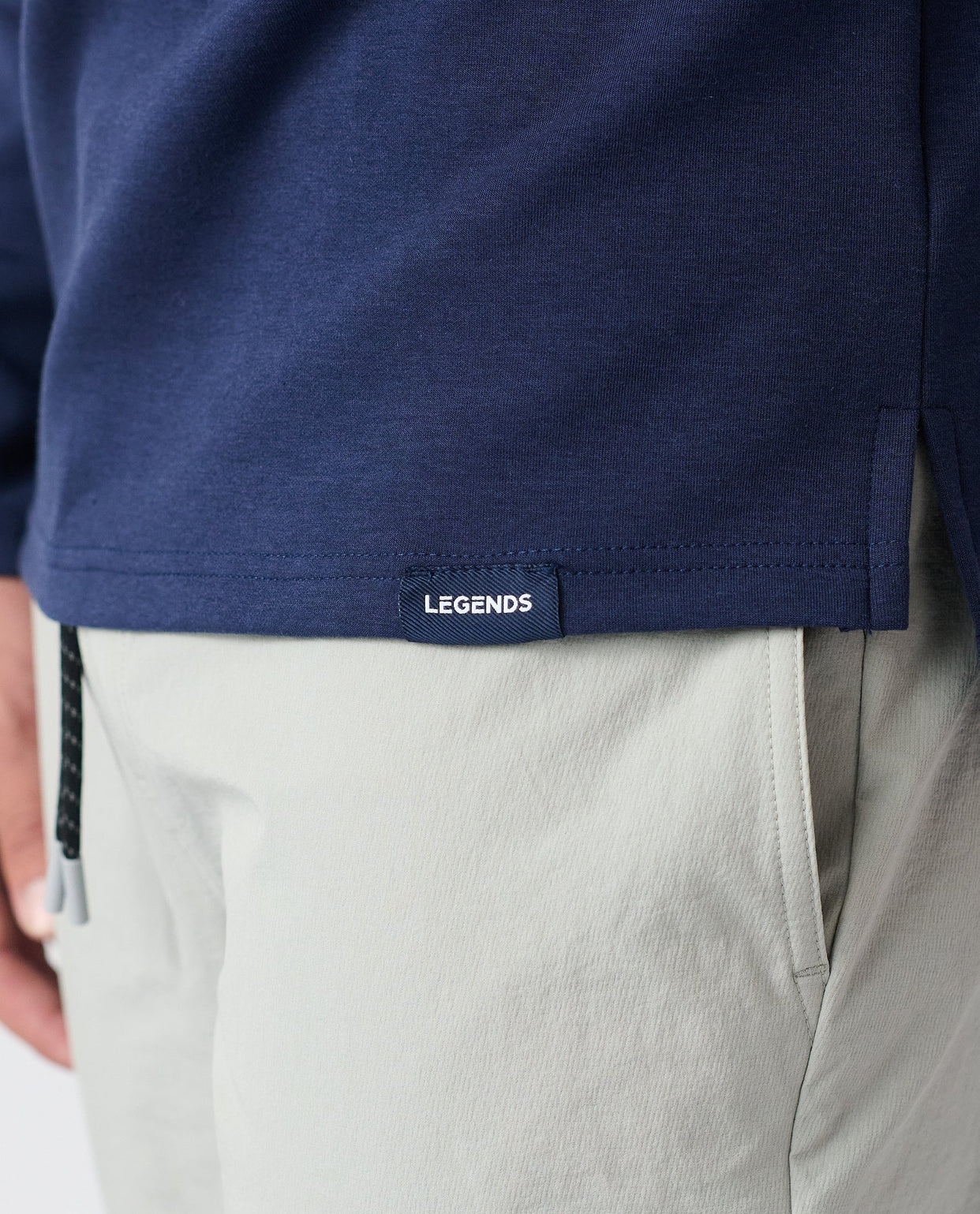 Navy quarter zip pullover with white ribbed trim at hem and "LEGENDS" brand label visible.