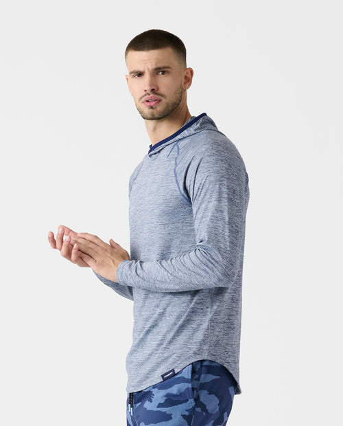 Light blue heather long-sleeve hooded sweatshirt with navy hood trim, shown on male model.