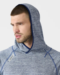 Men's blue heather hooded long-sleeve shirt with navy trim and raglan sleeves worn by model.