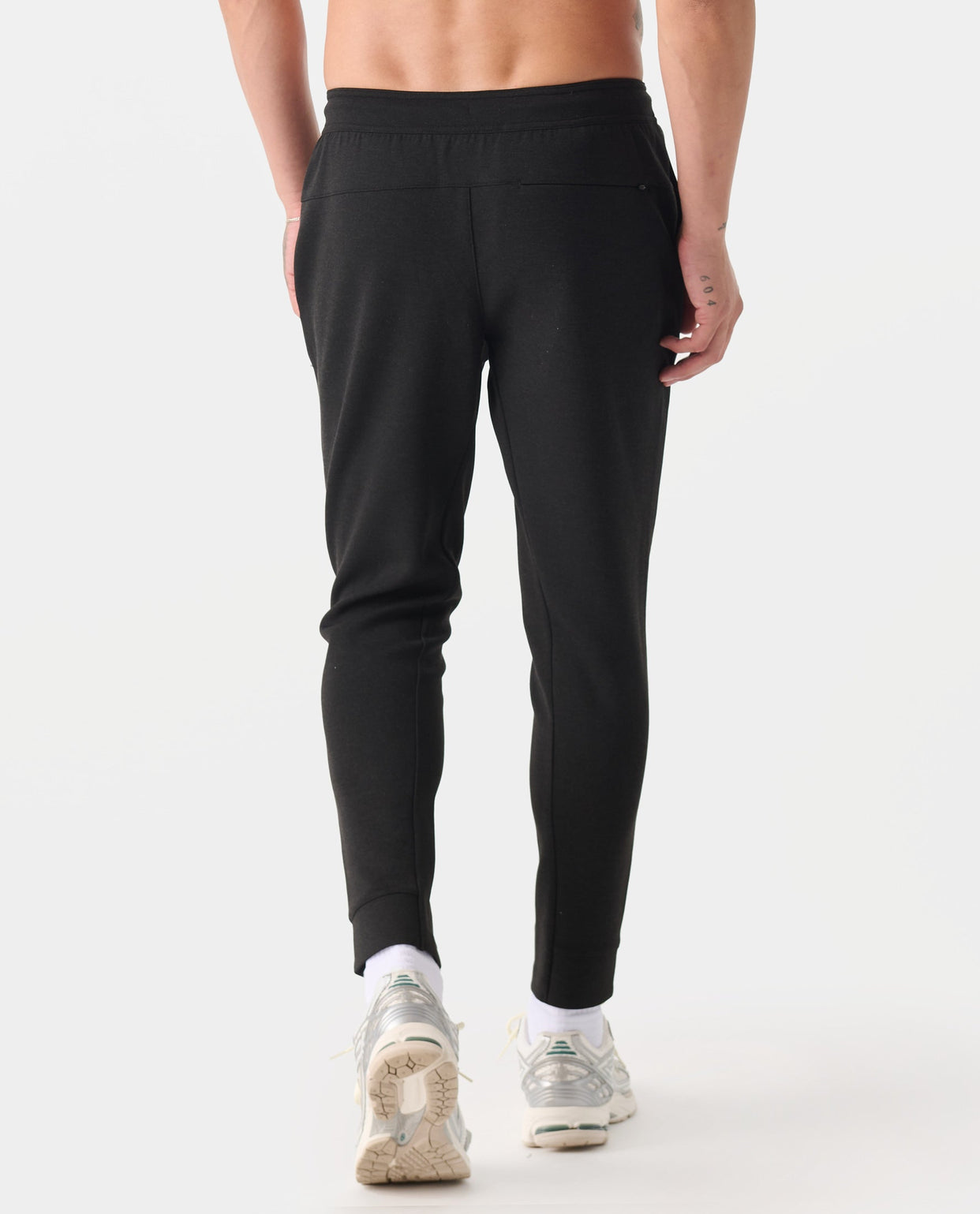 Black heather joggers with elastic waistband and tapered ankles, shown on model from waist down.
