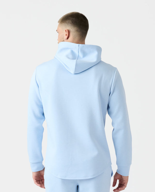 Man wearing light blue Hawthorne Tech hoodie with drawstring hood, shown from back view.