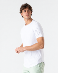 White short-sleeve t-shirt with curved hem, crew neckline, worn by man against neutral background.