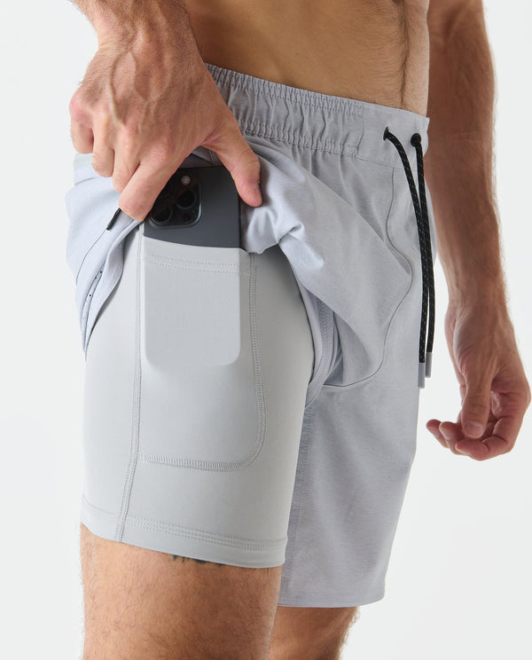 Light gray heather shorts with front pocket and drawstring, shown with phone in side pocket.
