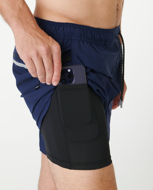 Navy shorts with white stripe detail and black compression liner with phone pocket.