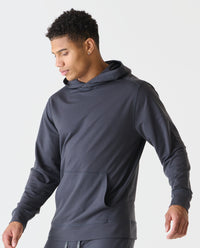 Charcoal gray hoodie with drawstring hood, kangaroo pocket, and ribbed cuffs on a model.