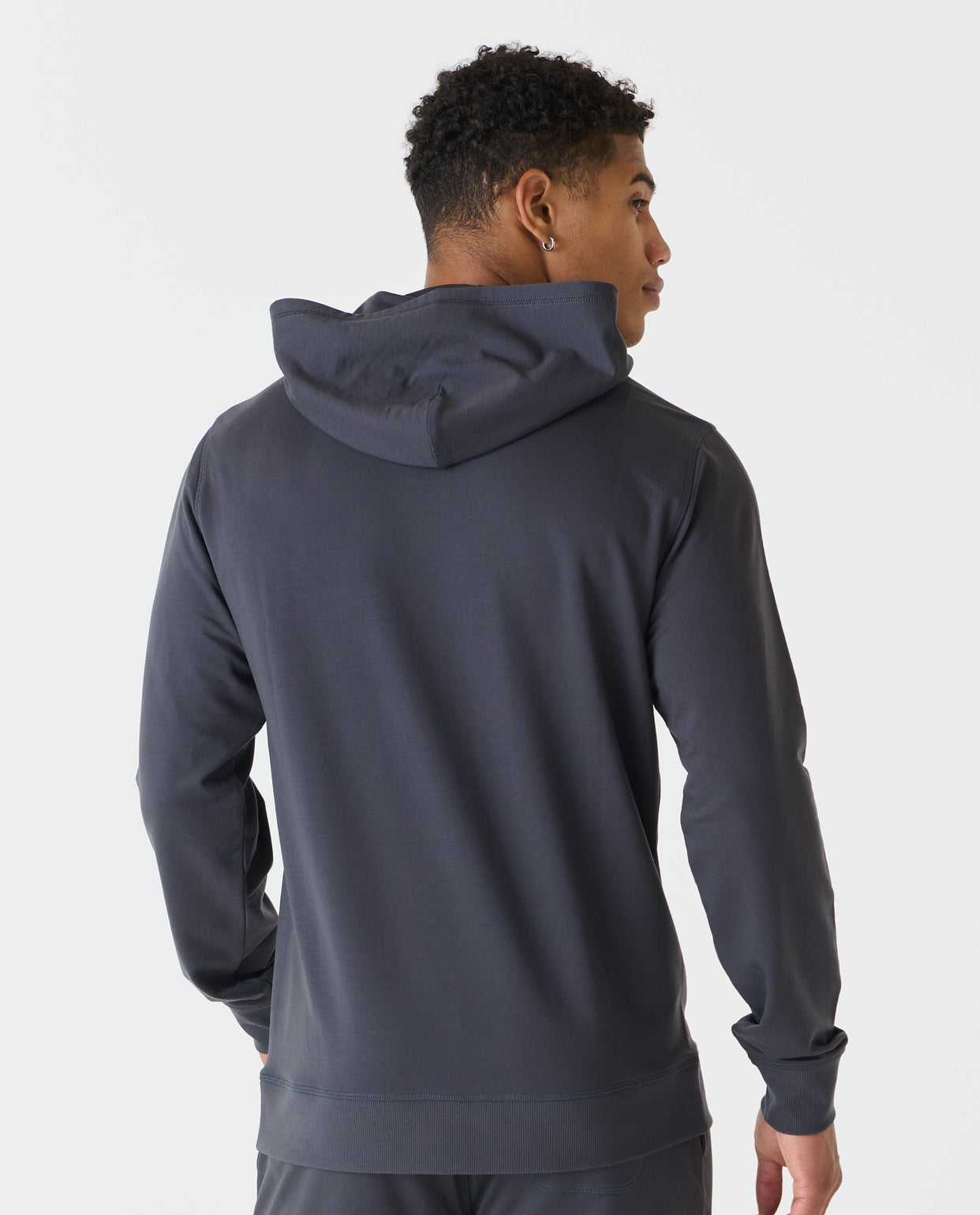 Charcoal gray pullover hoodie with drawstring hood, shown from back on model.