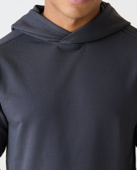 Charcoal gray pullover hoodie with ribbed hood and long sleeves, worn by a man.