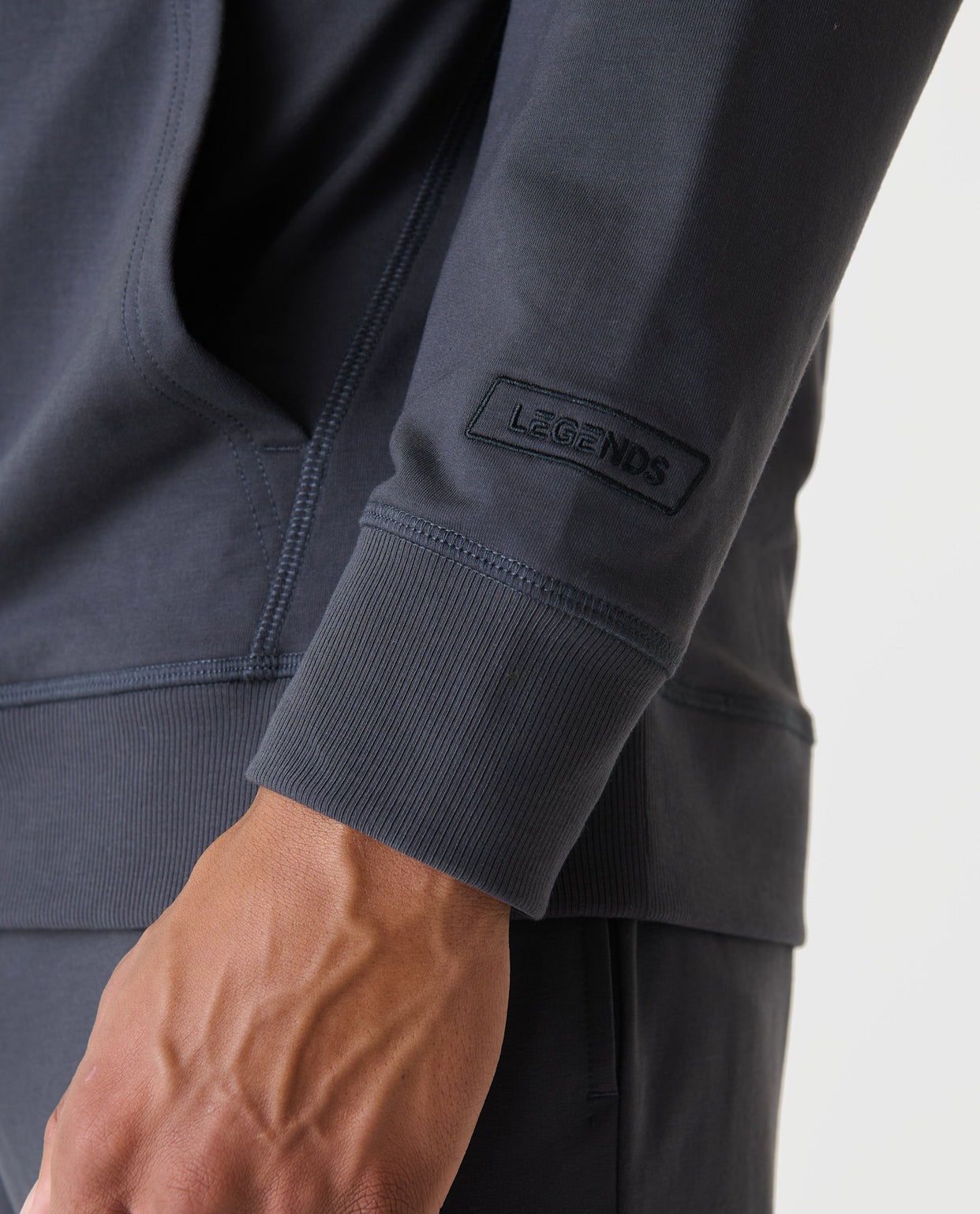 Charcoal gray hoodie with full front zip, ribbed cuffs, and "Legends" brand label on sleeve.